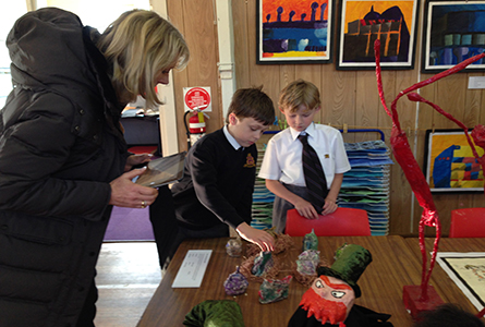 Hutchins students showing conference participants their artwork.