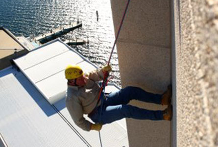 Headmaster Warwick Dean abseiling from the top of Wrest Point Casino.