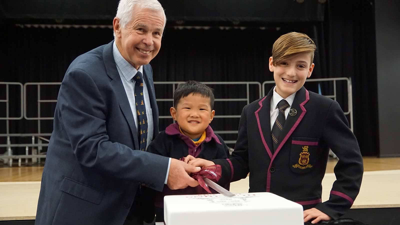 President of the Hutchins School Old Boys’ Association Mr Barrie Irons, Elliott Lee (Pre-Kindergarten) and Thomas Birkett (Year 6) cutting the Anniversary Cake.