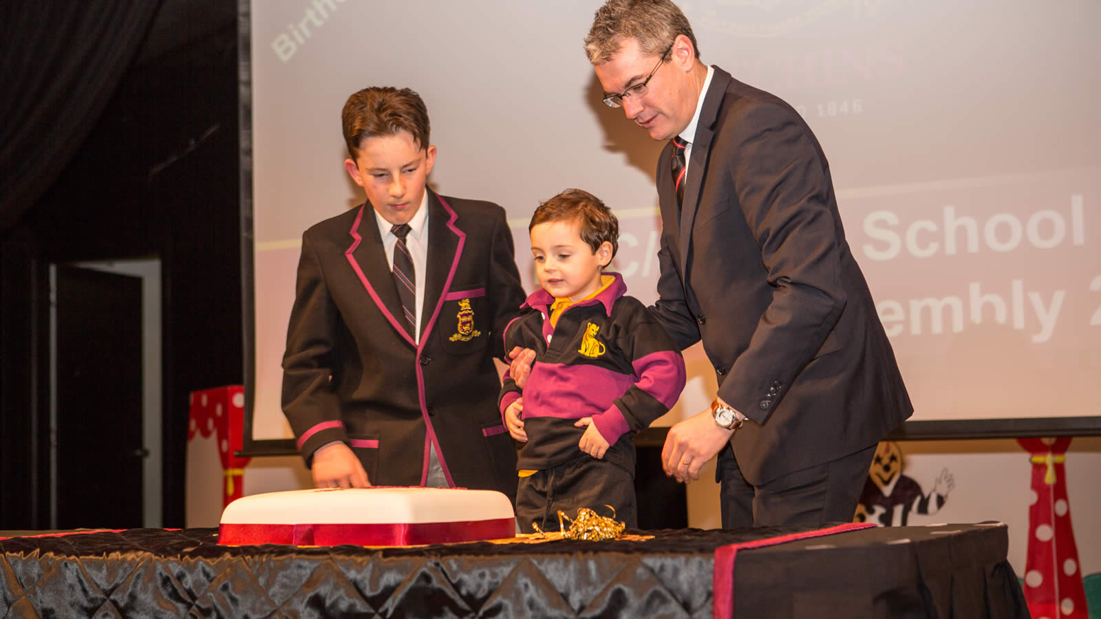 Lloyd Lucas, Aleksandar Stanojevic and Mr Gene Phair cutting the Anniversary Cake. (large)