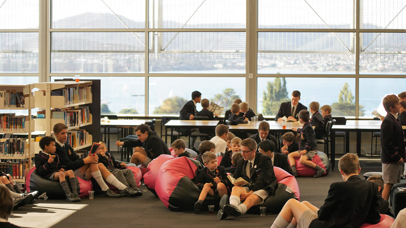 Year 2 and Year 12 students sharing time in the Nettlefold Library. (large)