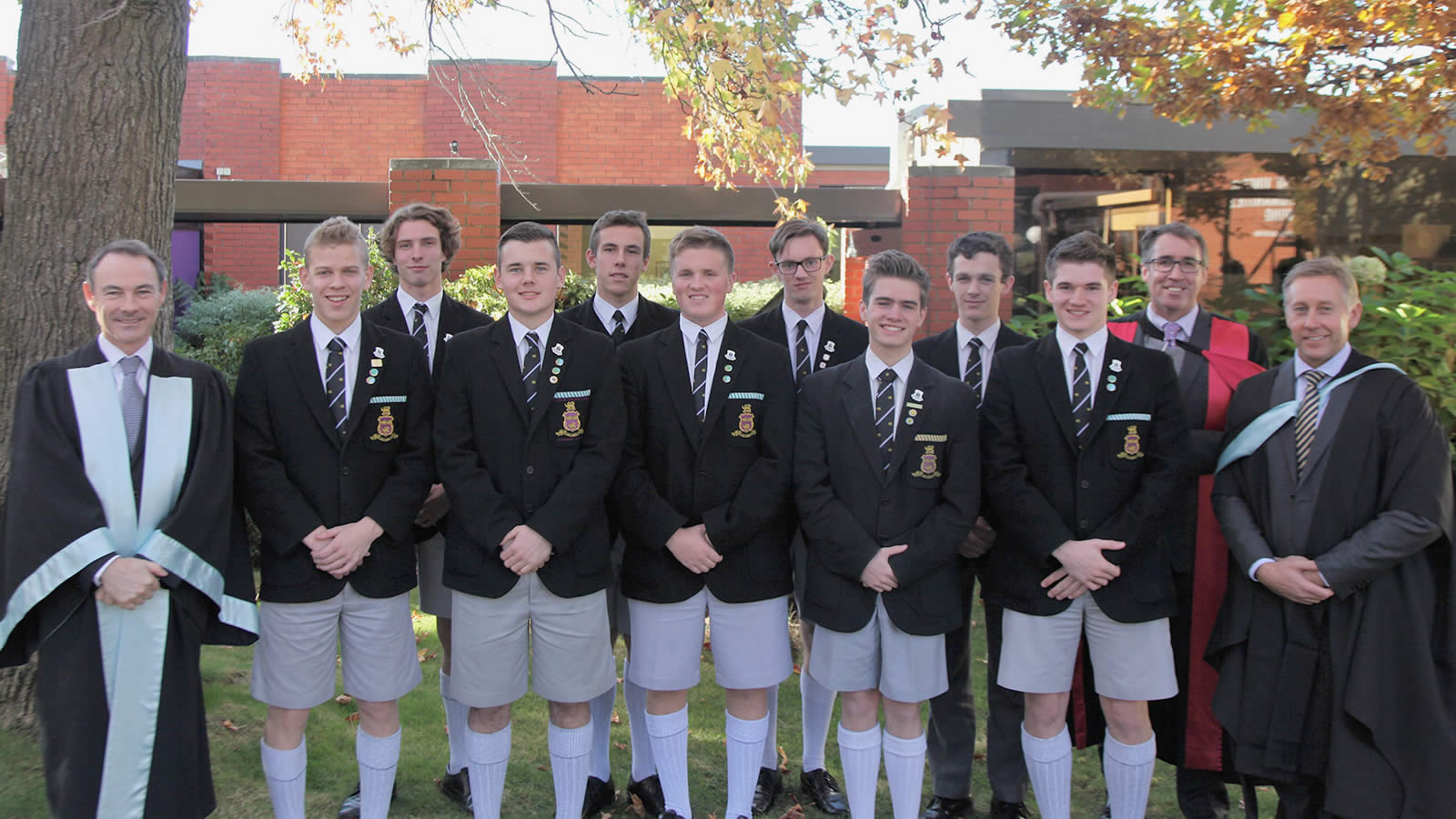 Dr Rob McEwan (Headmaster), Dr Adam Forsyth (Deputy Headmaster) and Mr Roger McNamara (Head of Senior School) with the newly inducted Prefects.