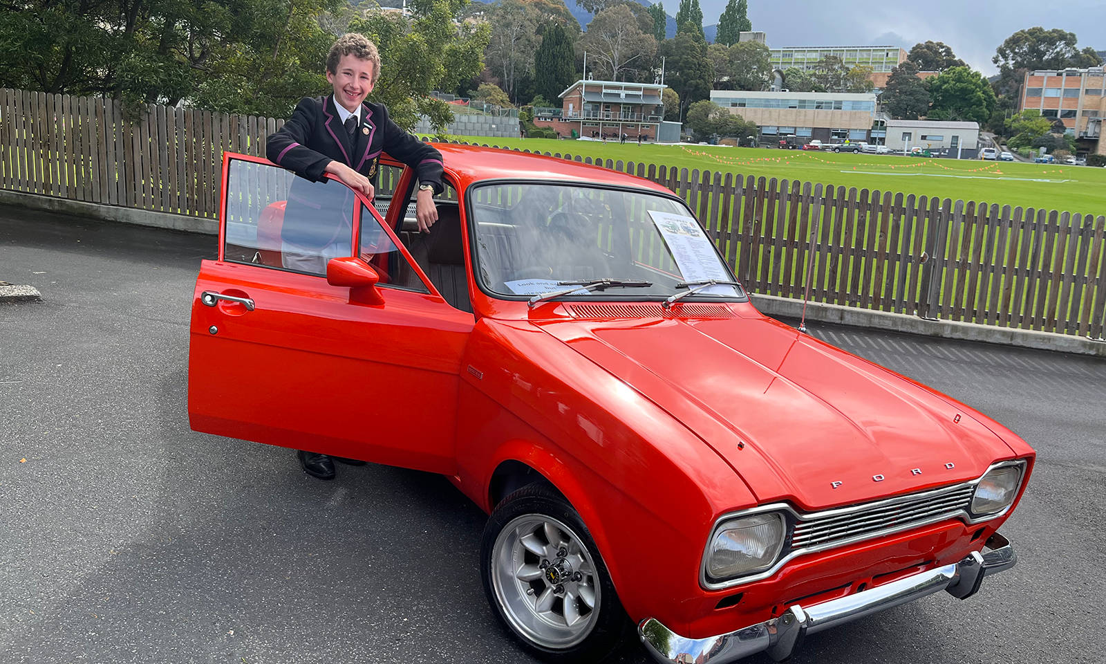 Lucas Dooley with his restored Ford Escort